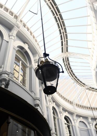 Looking up to the glass ceiling in a shopping arcade.