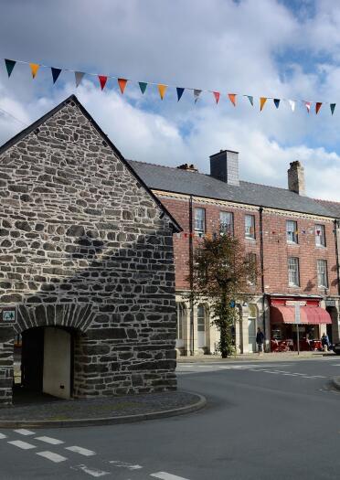 The street view of the stone and brick properties in the town of Llanidloes on the Glyndwr's Way walk.