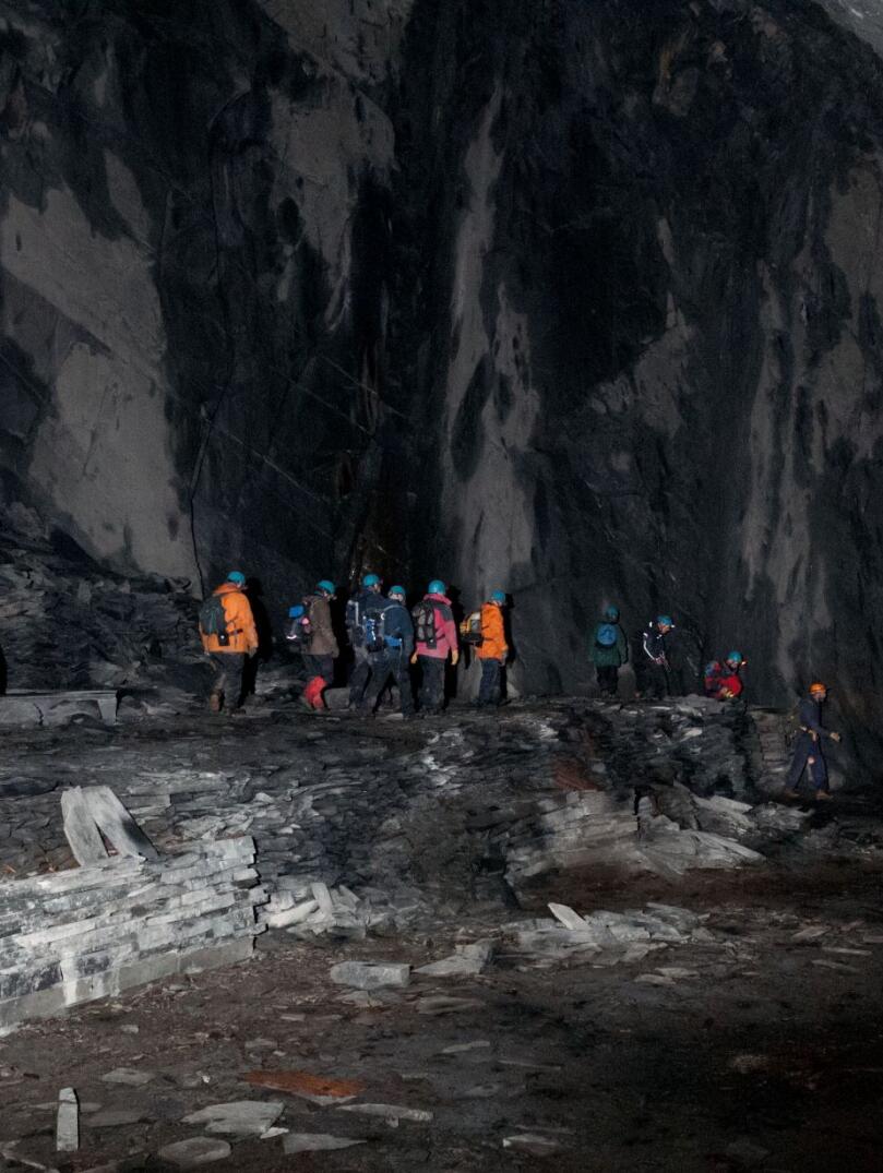 Group of people exploring an underground cave.