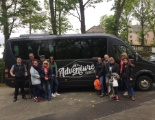 Group of people standing in front of a minibus