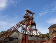 A winding wheel and workhouse in a former mine.