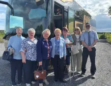 A group in front of a coach.