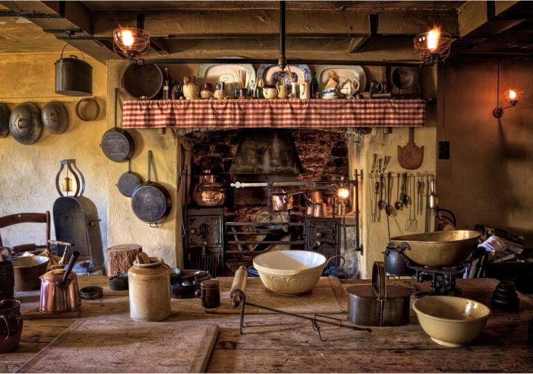 Kitchen dating back to 1870 with pots, pans and utensils hanging around the fire place.