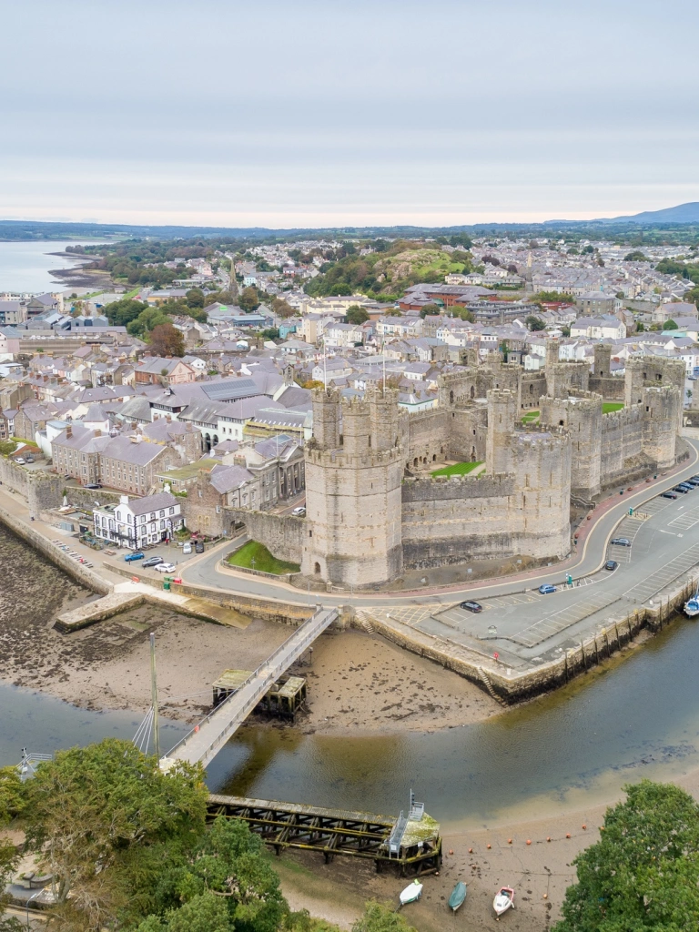 Aerial shot of a castle, strait and town.