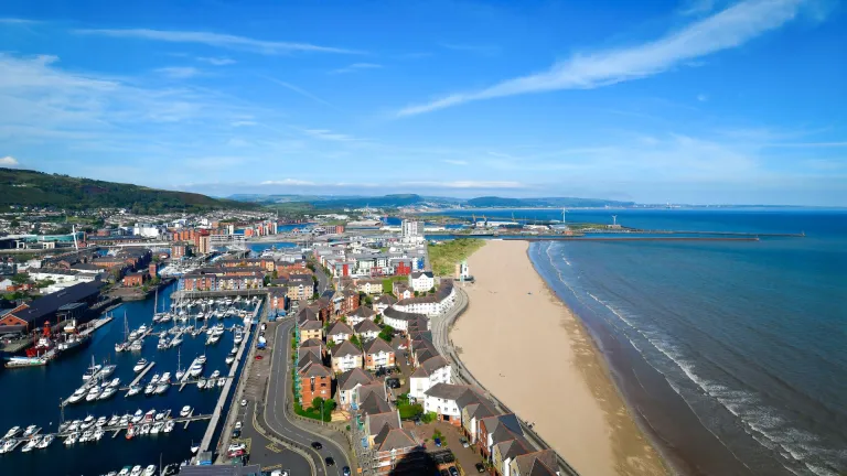 Sweeping view of the harbour and coastline of Swansea Bay.