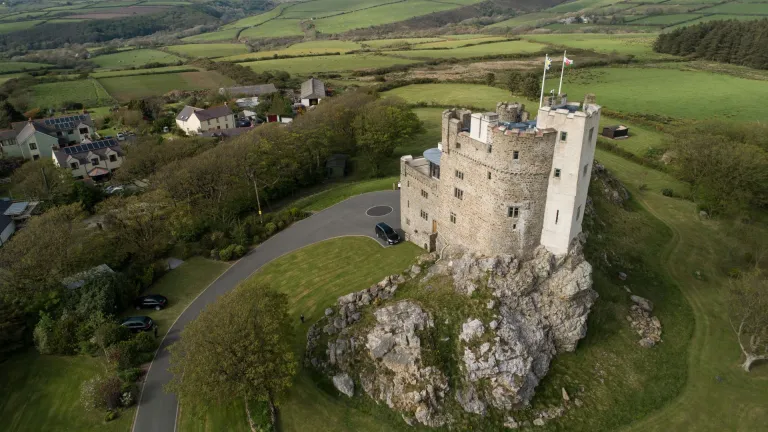 An aerial shot of Roch Castle set amongst the rolling hills and valleys.