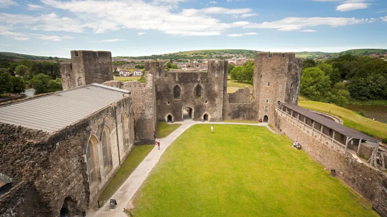 Inside the courtyard of a castle surrounded by the castle walls and moat.