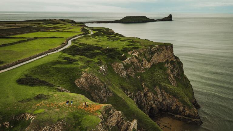Aerial shot of Rhossili Bay with Worm's Head in the foreground.
