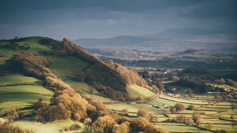A view of Merlin's Hill and the dramatic hills and mountains in the background.