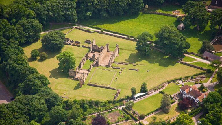Aerial shot of the ruins of an abbey.