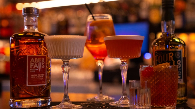 Display of cocktails at bar with bottle of Aber Falls whisky