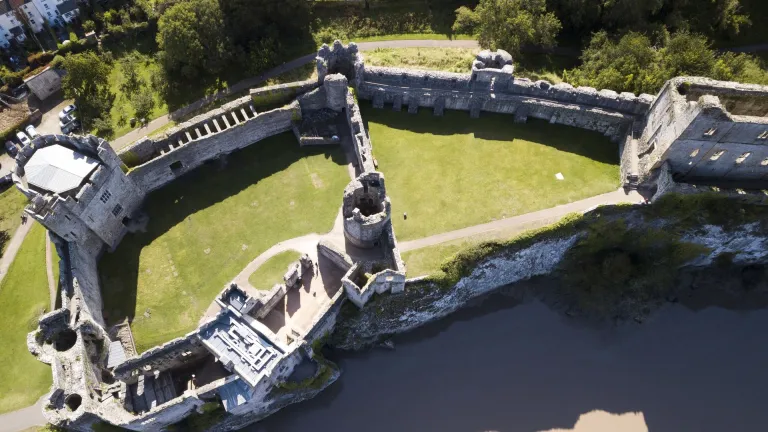 Aerial shot of the walls and tower of a castle.