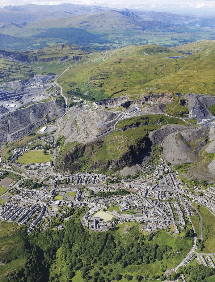 Aerial shot of a village and the slate landscape beyond.