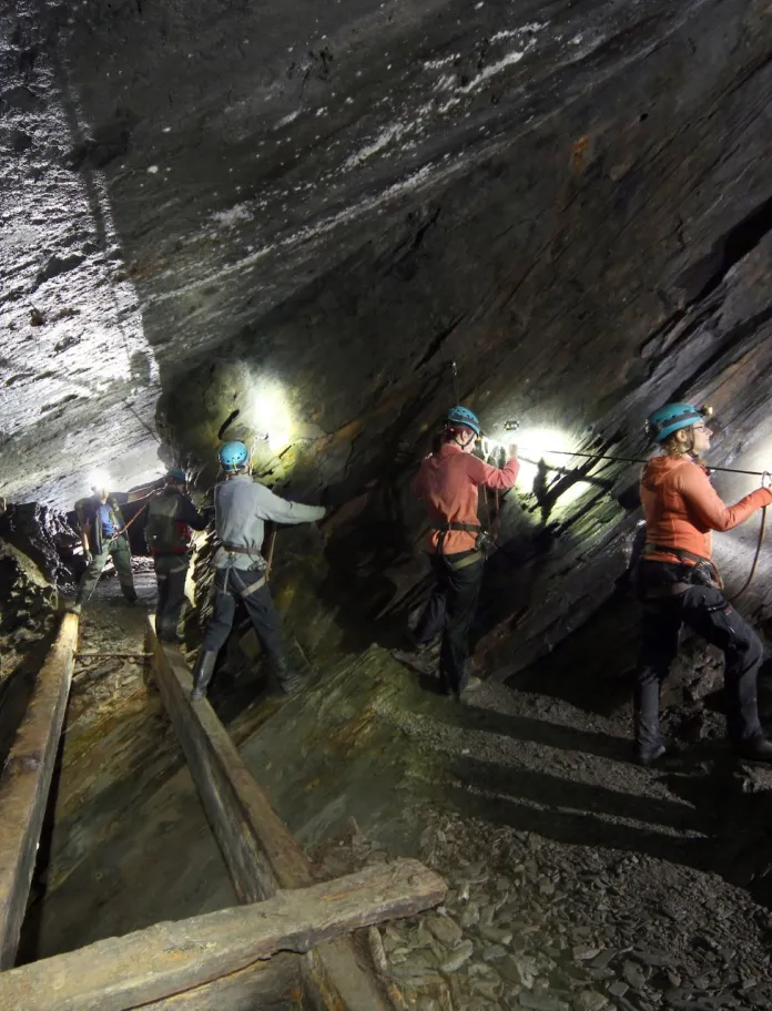 Teams traverse on of the underground bridges at Go Below Xtreme experience.