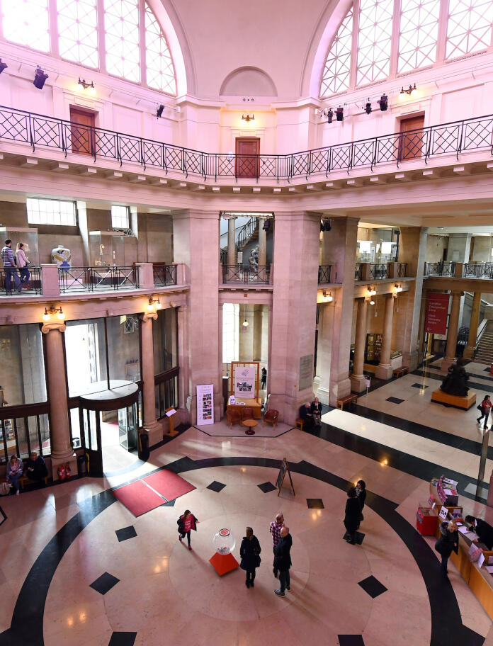 The grand entrance of National Museum Cardiff showing first floor levels and large windows.