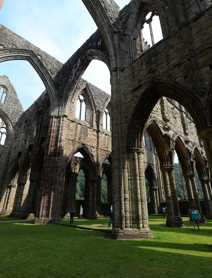 Interior shot of an old abbey with the sunlight casting shadows.