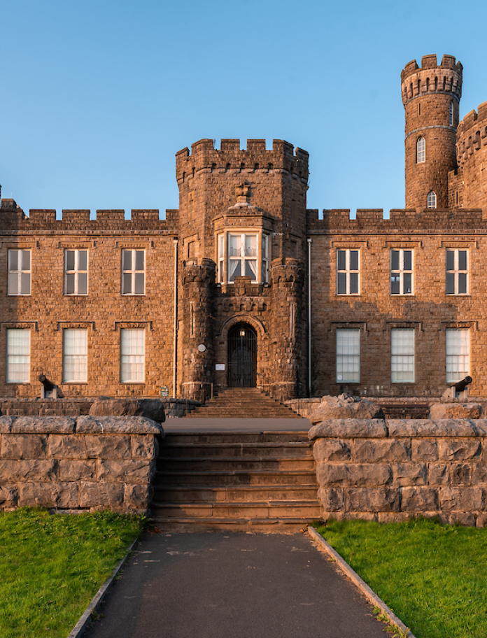 Exterior of a grand castellated mansion.