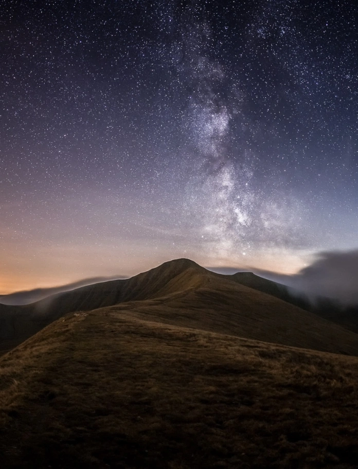 Stars in the night sky with mountains.