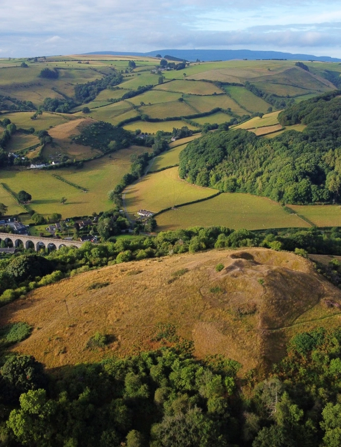 Site of where a castle stood with a viaduct in the distance.