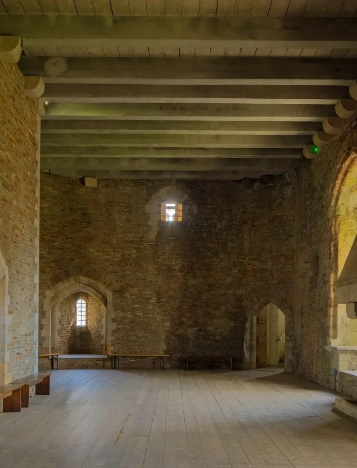 A grand fireplace inside the walls of a castle.
