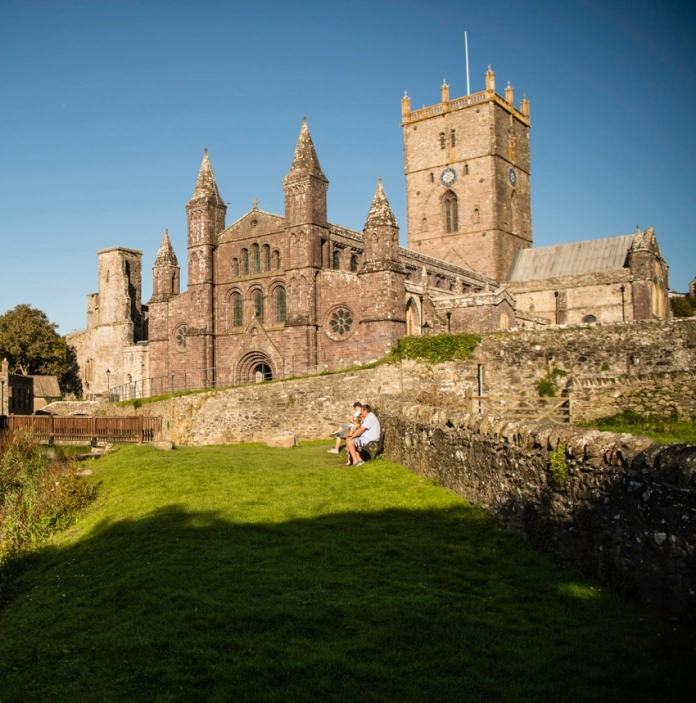 The ruins of St Davids Bishop's Palace and St David's Cathedral, side by side in the sunshine.