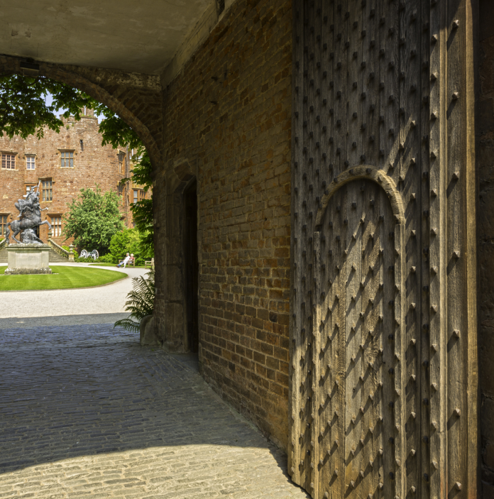 The gateway and corridor leading to Powis Castle seen in the background.