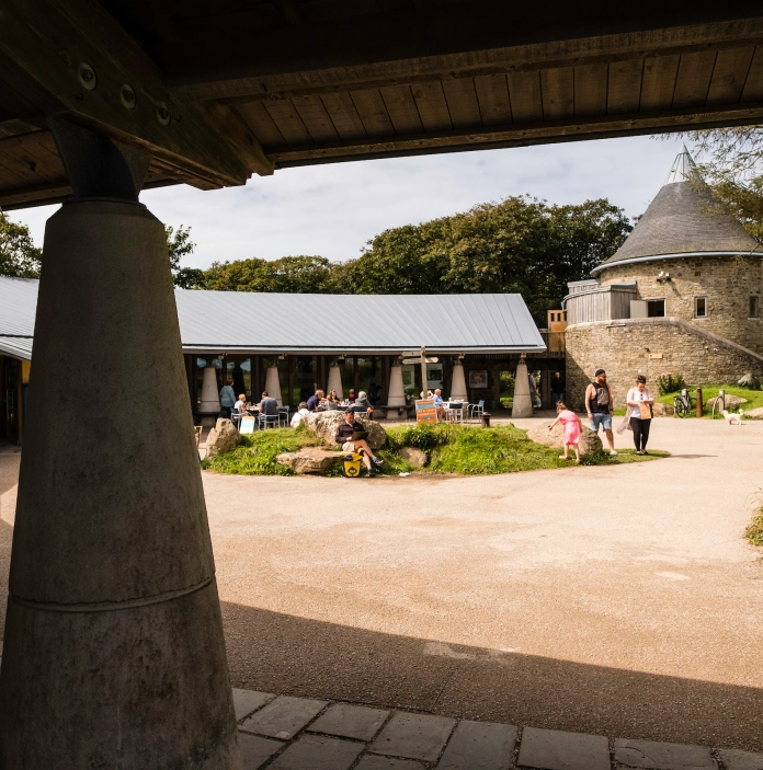 People sitting outside Oriel y Parc Gallery and Visitor Centre.