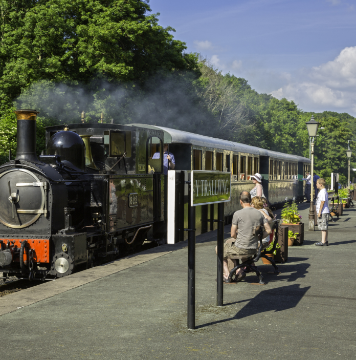 Locomotive at station Welshpool and Llanfair Light Railway with passengers on the platform.
