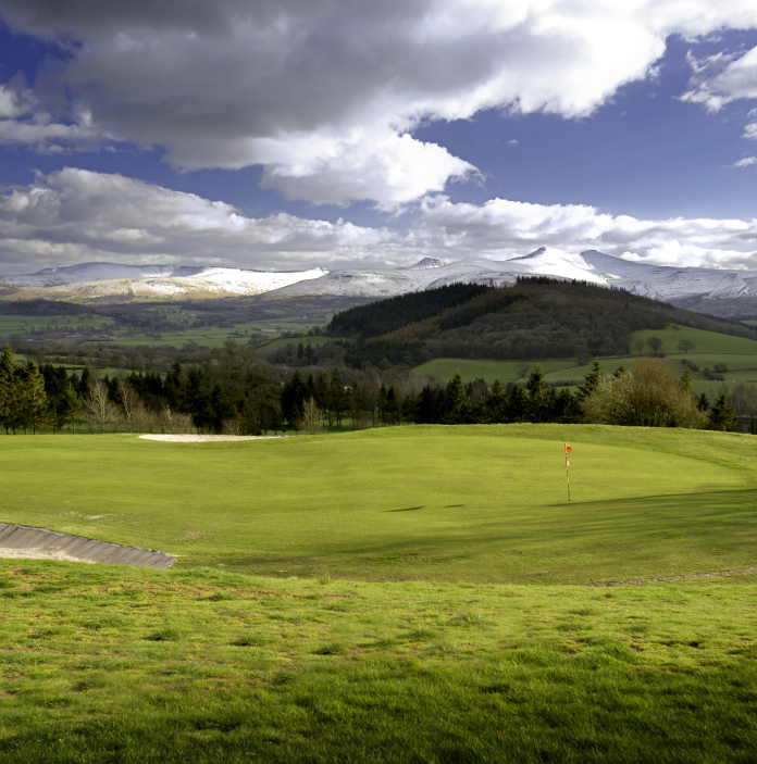 Dramatic mountains seen from one of the greens at Cradoc Golf Club.