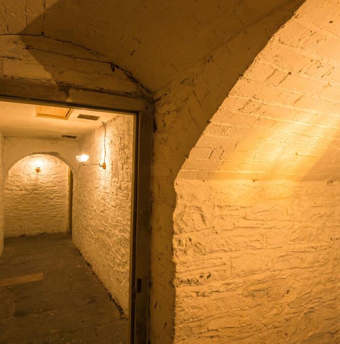 Underground whitewashed tunnels of the prison area at The Judge's Lodging.