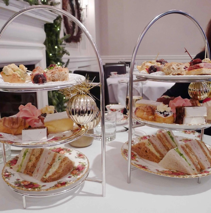 Afternoon tea on two silver serving dishes.