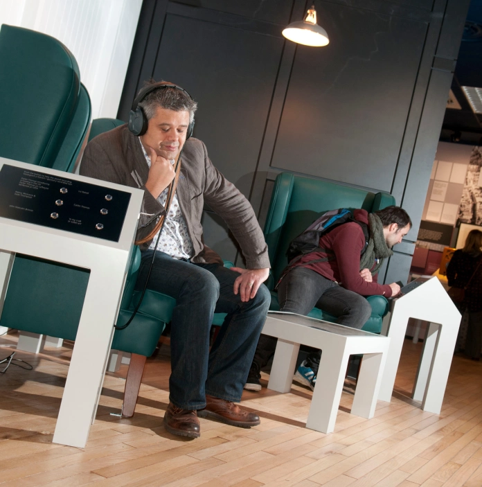 man with headphones sat listening to information.