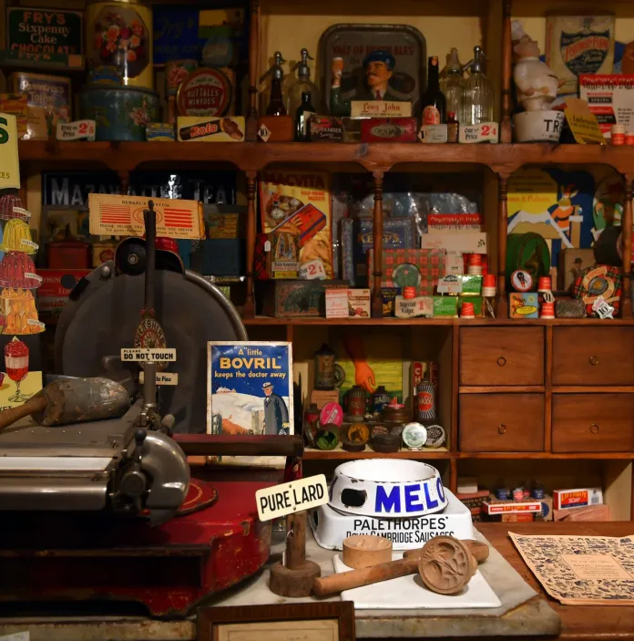 Vintage food products displayed in a historical shop at a museum.