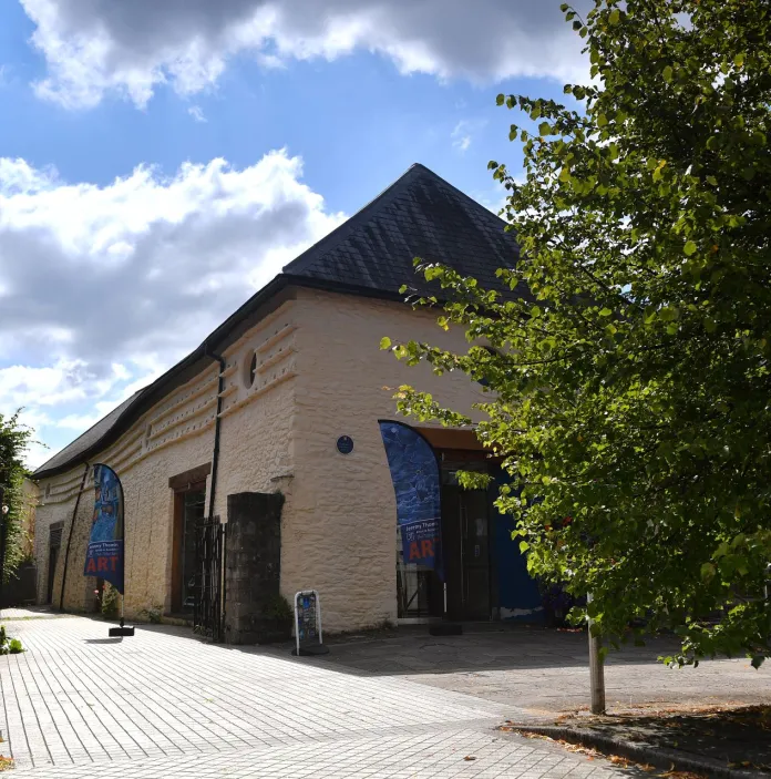 External view of a barn  on a sunny day which houses exhibits.