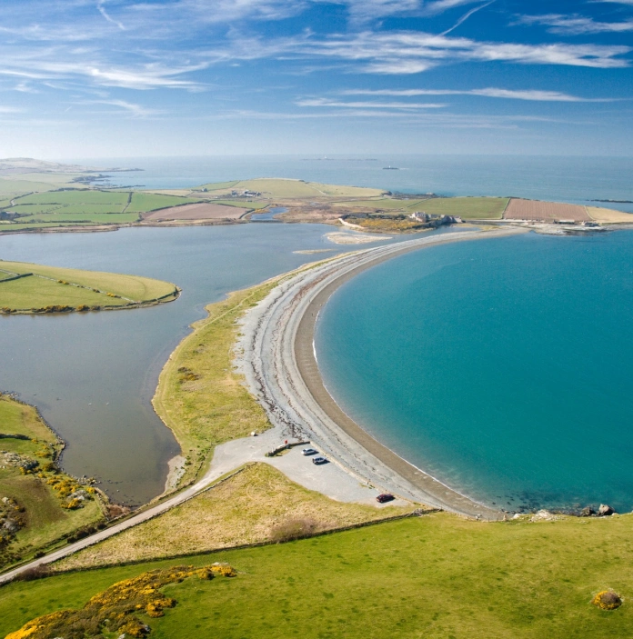 A stretch of coastline separated by the sea and a lake.