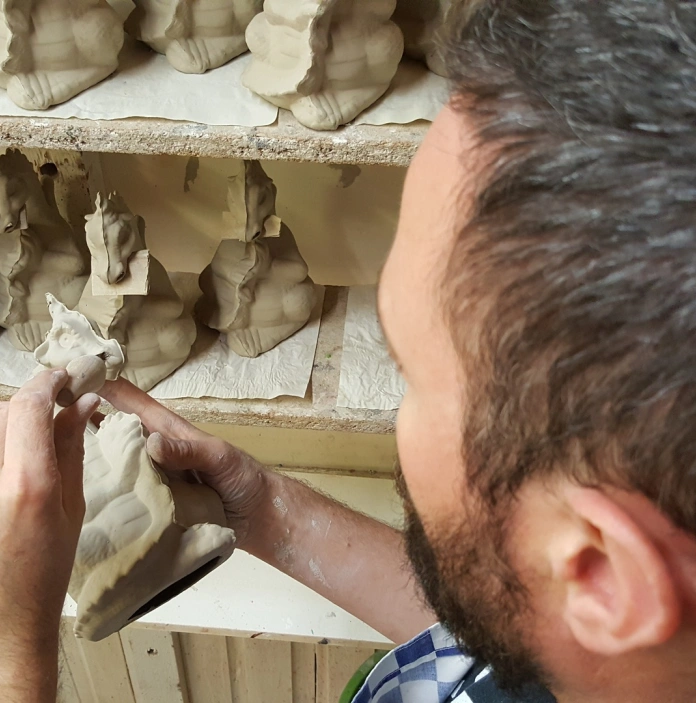 A man sculpting ornamental dragons.