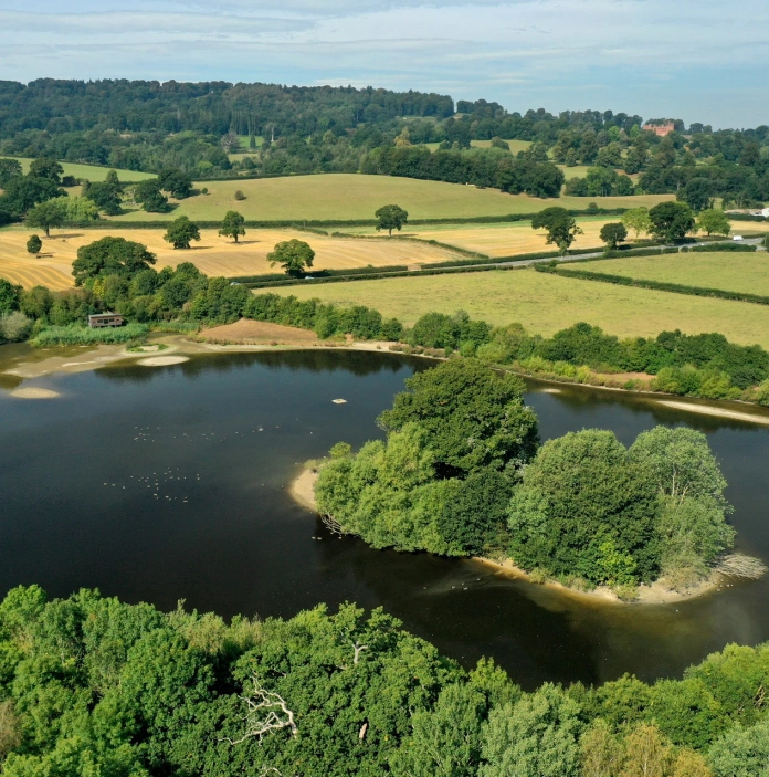 Aerial shot of a bird hide, lake and island.