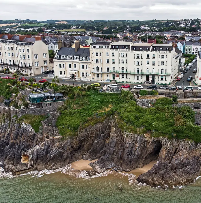 Aerial shot of a sightseeing bus travelling along the coastal road.