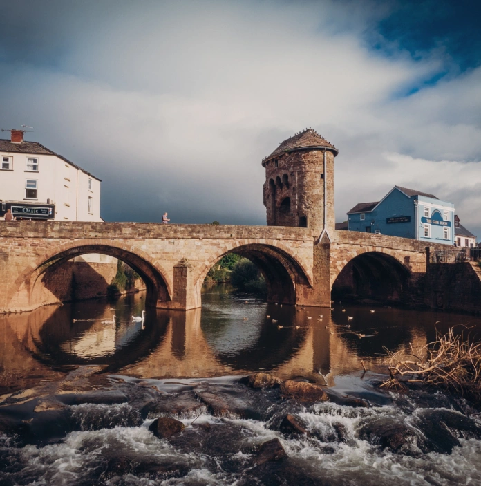 A bridge stretching over a flowing river.