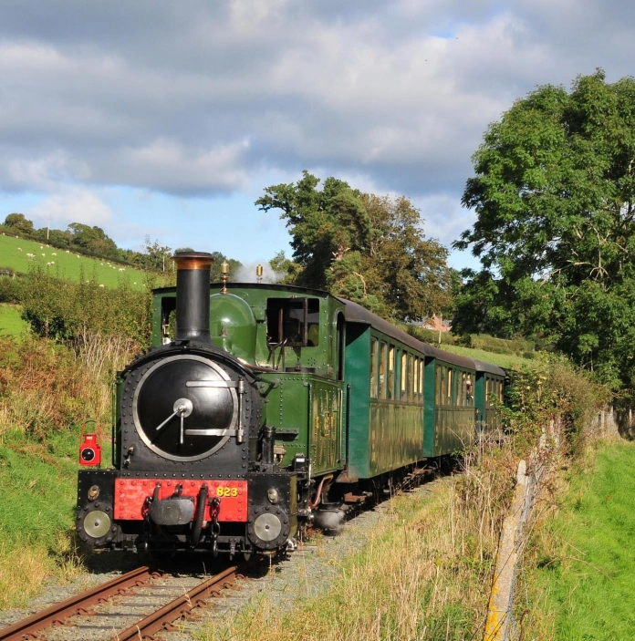 A steam train travelling through the countryside.