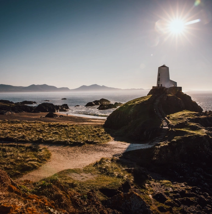 Steps leading to a lighthouse on a coast path.