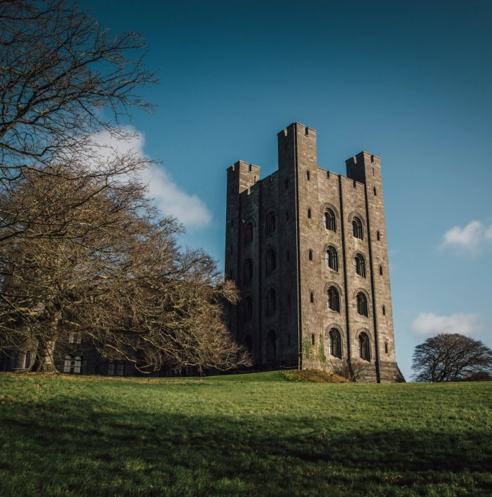 View of a castle amongst trees on a sunny winter's day.