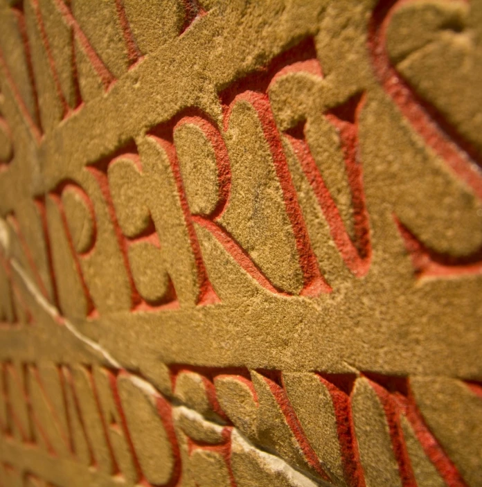 Calligraphy on a broken stone tablet in a museum.