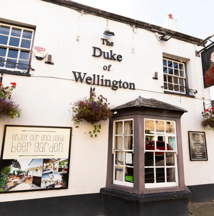 External view of a pub in a high street.