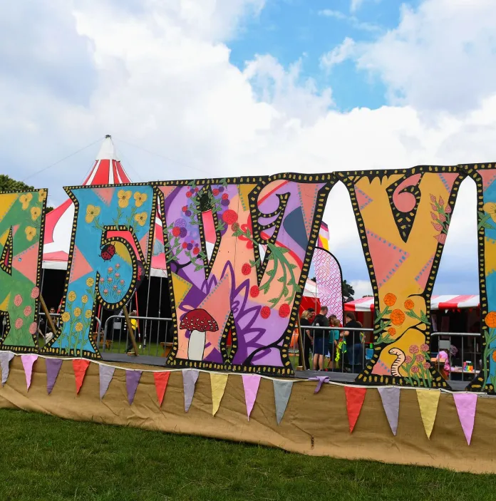 A colourful sign promoting a festival.