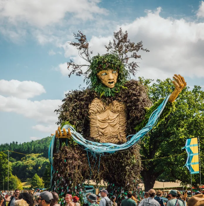 A giant effigy made of forestry material.
