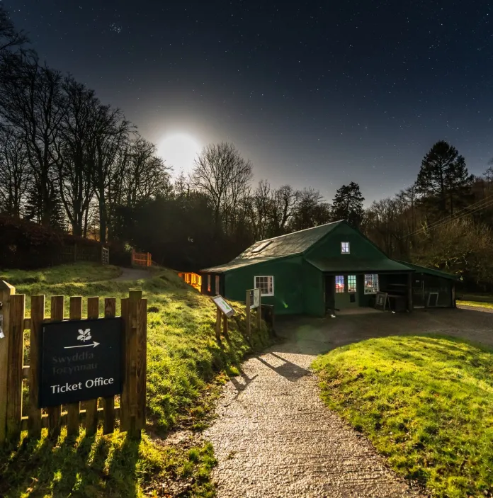 A gate opening to a ticket office for an historic house.