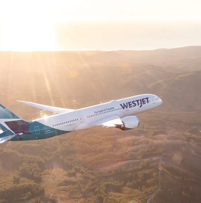 Aircraft flying high above a mountain range.