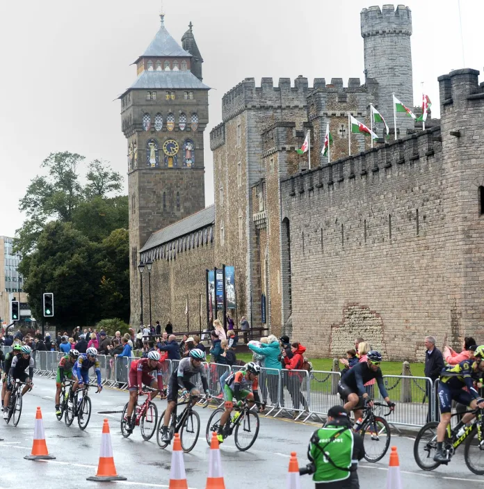 Competitive cyclists passing by a city centre castle.