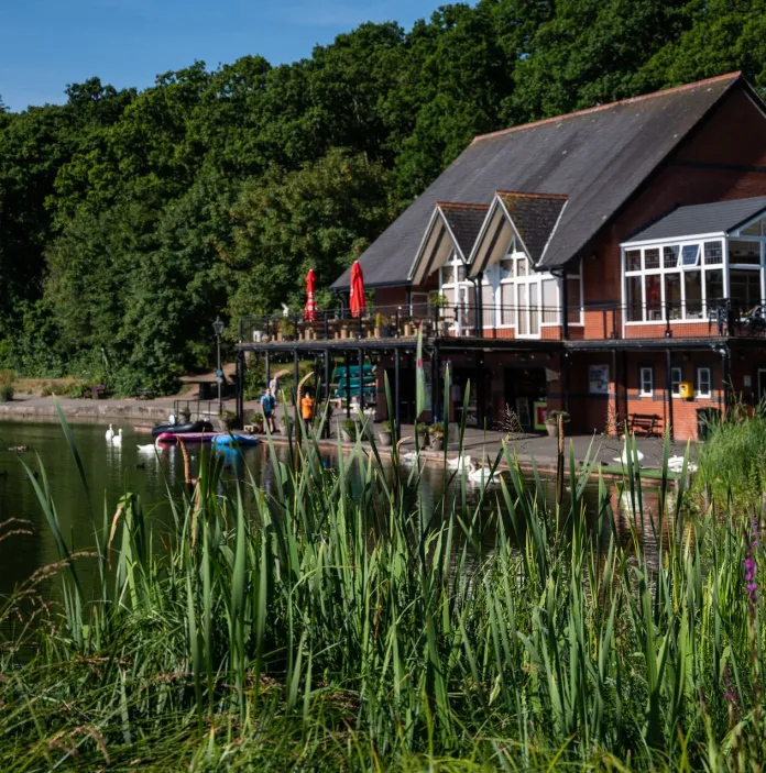 A boathouse next to a lake.